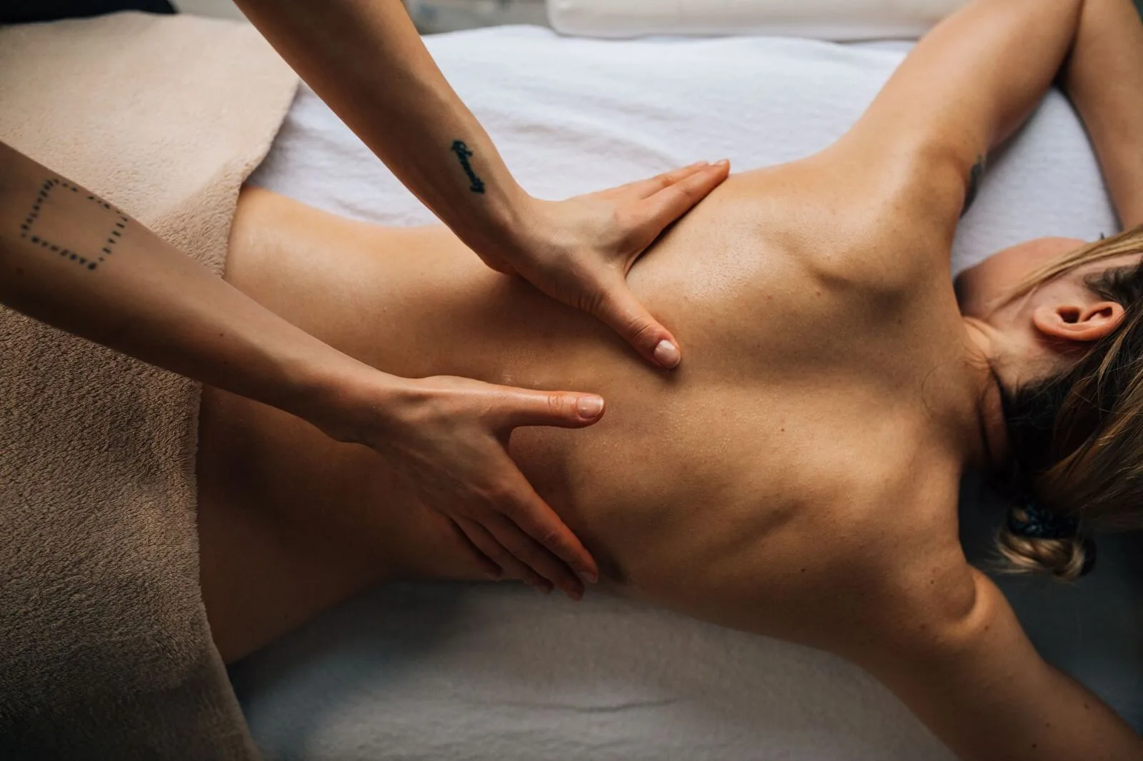 Focused pressure along a client's shoulder blade