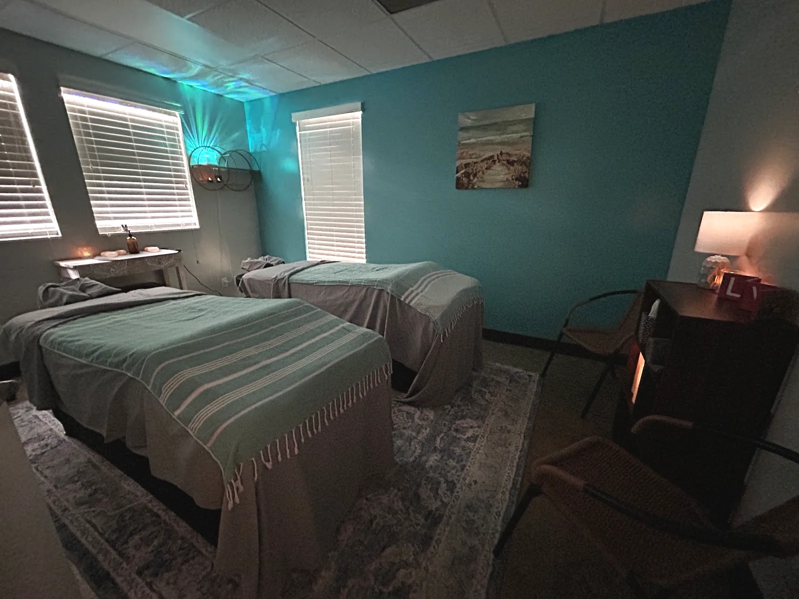 Synergy's own couples room: two tables side by side against the teal wall