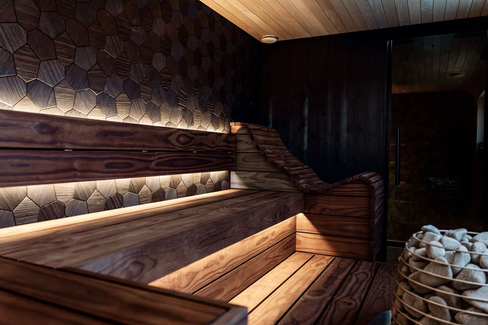A warmly lit wooden sauna bench